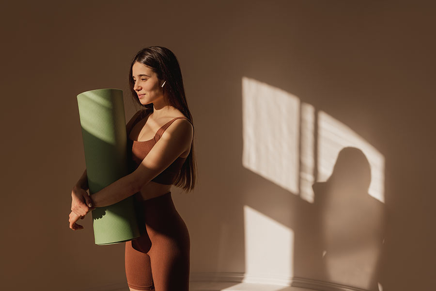 Person practicing simple yoga poses for daily calm in a peaceful indoor setting.